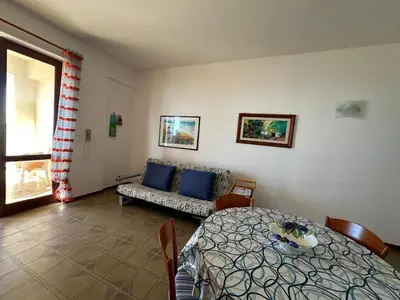 a living room with a bed and a couch at Casa Letizia in Alcamo