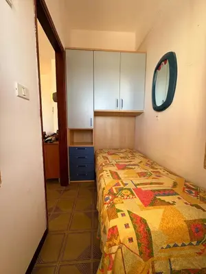 a bedroom with a bed and a mirror and cabinets at Casa Letizia in Alcamo