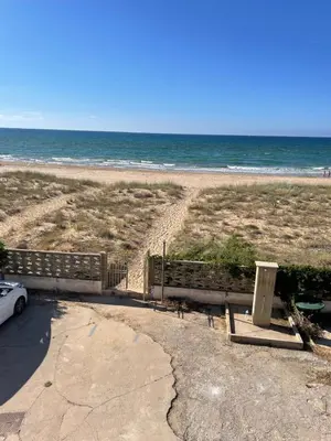 a car parked next to a beach with the ocean at Casa Letizia in Alcamo