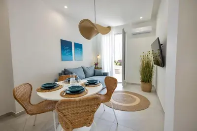 a living room with a table and chairs and a couch at BellaVista in Cinisi