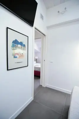 a white room with a picture on the wall at Maciuni Apartment in Palermo
