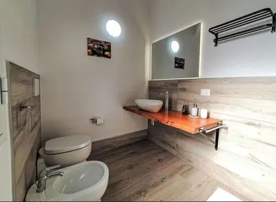 a bathroom with a toilet and a sink at Villa Charme & Relax in Campofelice di Roccella
