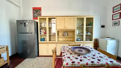 a kitchen with a refrigerator and a table in it at La Terrazza sul Mare in Palermo