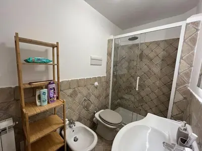 a bedroom with a bed with purple sheets and pillows at Full Semi-Garden apartment in Villa at Mondello in Palermo