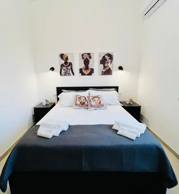 a bedroom with a large bed with two pillows at Il Moro di Ballarò - Palermo Rooms in Palermo