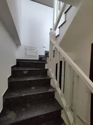 a stair case in a building with black stairs at V&J appartamenti in Carini