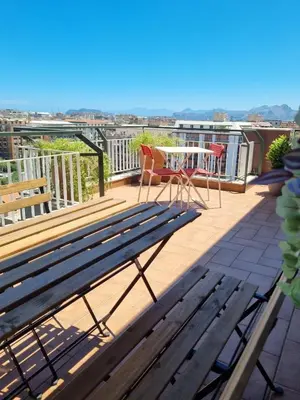 a deck with a bench and a table on a balcony at CITY HOUSE & FREE PARKING by Perry-Holiday moderno, panoramico e comodo fino a 6 ospiti in Palermo