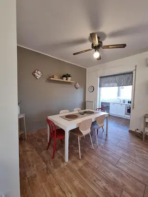 a dining room with a white table and chairs at CITY HOUSE & FREE PARKING by Perry-Holiday moderno, panoramico e comodo fino a 6 ospiti in Palermo