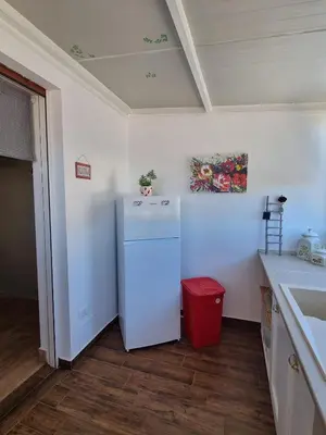 a kitchen with a white refrigerator and a red trash can at CITY HOUSE & FREE PARKING by Perry-Holiday moderno, panoramico e comodo fino a 6 ospiti in Palermo