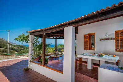 a house with a view of a patio at Casa vinz in Scopello