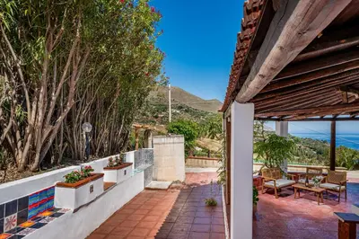 an outdoor patio with a view of the ocean at Casa vinz in Scopello