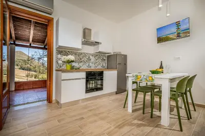 a kitchen and dining room with a table and chairs at Casa vinz in Scopello