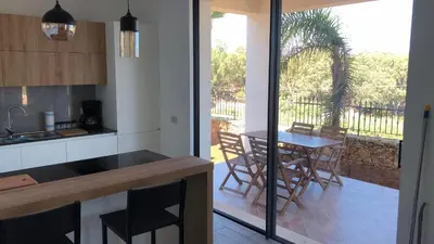 a kitchen with a table and chairs and a patio at Villa Marina Luxury in Balestrate