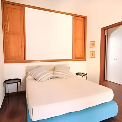 a white bed in a room with a window at Antico frantoio in Palermo