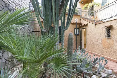 a group of plants in front of a building at Casa Trionfante in Santa Flavia