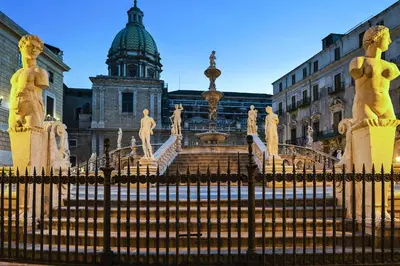 a gate in front of a building with a fountain at Terrazza Trionfante in Santa Flavia