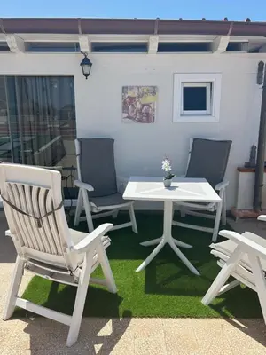 a patio with two chairs and a table and a table at Camera con terrazza in San Vito lo Capo