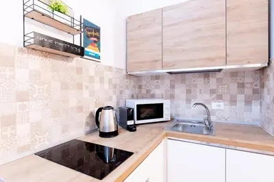a kitchen with a sink and a microwave at Cappuccini 62 House in Palermo