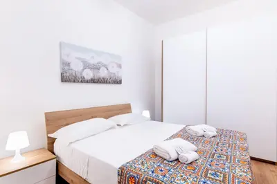a bedroom with two beds with towels on them at Cappuccini 62 House in Palermo