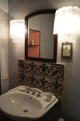 a bathroom with a sink and a mirror at La dimora del genio in Palermo