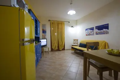 a kitchen and living room with a yellow refrigerator at Balconi Sul Mare Appartamenti in Castellammare del Golfo