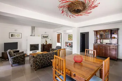 a living room with a wooden table and chairs at Villa Angelica by Wonderful Italy in Castellammare del Golfo
