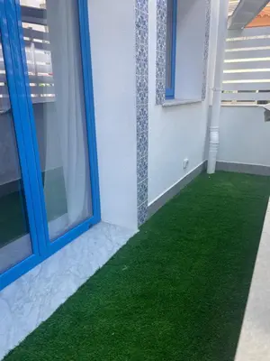 a room with a green floor and windows at Panhouse in Palermo