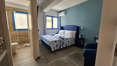 a bedroom with a bed and a blue wall at Panhouse in Palermo