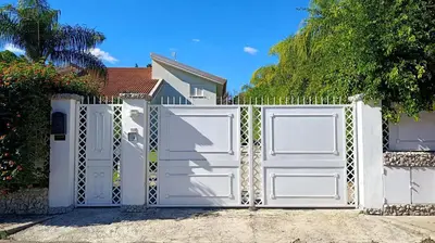 a white gate in front of a house at Villa Ginevra in Mondello