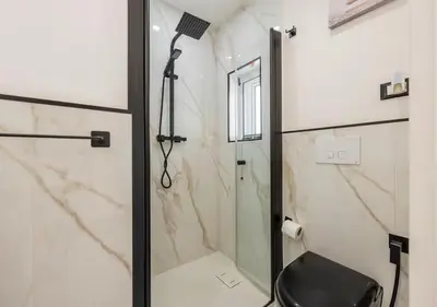 a bathroom with a shower with a glass door at Onda blu in Palermo