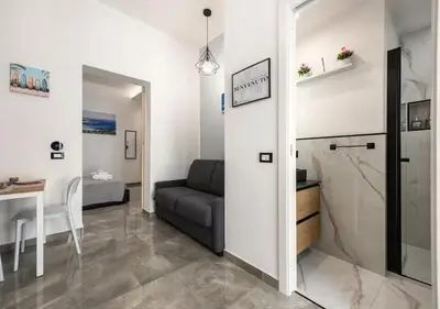 a living room with a couch and a table at Onda blu in Palermo