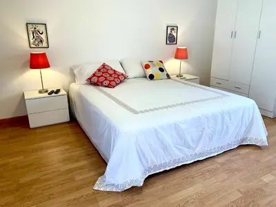 a bedroom with a white bed with two lamps at Daydream in Trabia