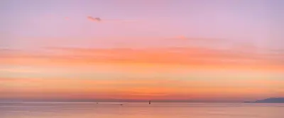 a sunset over a body of water with a sky at Daydream in Trabia