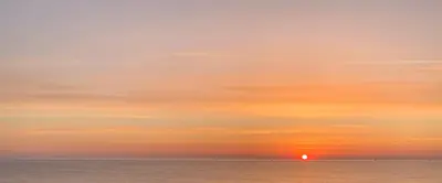 a sunset over the ocean with the sun setting at Daydream in Trabia