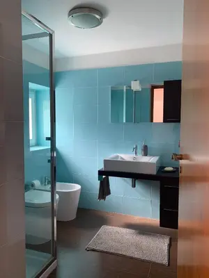a blue bathroom with a sink and a tub at Daydream in Trabia