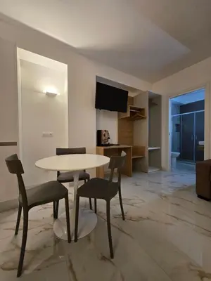 a living room with a table and chairs in a room at Ma Gra Ví in Terrasini