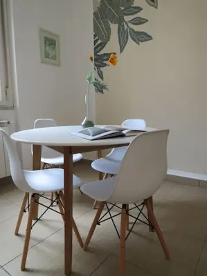 a dining room table with white chairs and a table at Relax nel verde- GioDaPi Palm in Palermo