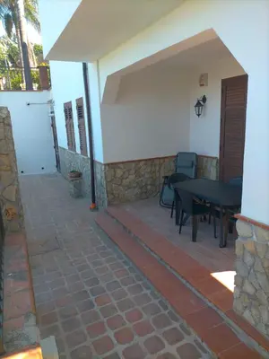 a patio of a house with a table and chairs at Menzel el Emir in Misilmeri