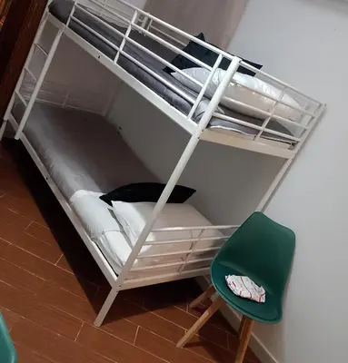 a bunk bed with a green chair in a room at Mondello suite apartment in Mondello