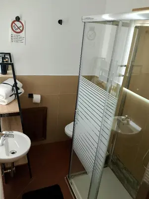 a bathroom with a shower and a toilet and a sink at Mondello suite apartment in Mondello