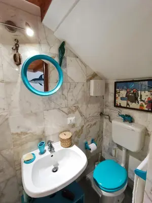 a bathroom with a sink and a toilet and a mirror at Casuzza del mare in Castellammare del Golfo