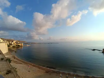 a view of a beach on a cloudy day at Casuzza del mare in Castellammare del Golfo