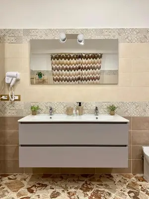 a large white bath tub in a bathroom at Affittacamere bm in Palermo