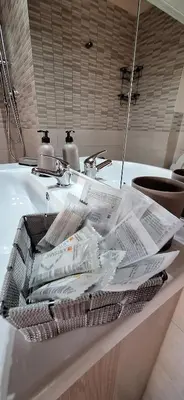 a bathroom sink with a pile of newspapers at Sweet Dreams a casa di Alex in Palermo