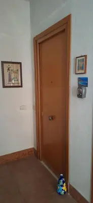 a wooden door in a room with a toy next to it at Sweet Dreams a casa di Alex in Palermo