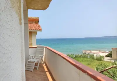 a balcony with two chairs and a view of the ocean at Sizilien 3 in Trappeto