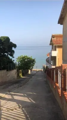 an empty street with the beach in the background at Sizilien 3 in Trappeto
