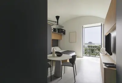 a kitchen and living room with a table and chairs at Trinacria Marina Apartment in Palermo