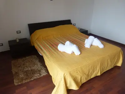 a bedroom with a bed with two towels on it at Villa Aurora Appartamento in villa con piscina in Bagheria