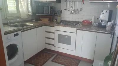 a kitchen with a sink and a washing machine at Villa Aurora Appartamento in villa con piscina in Bagheria